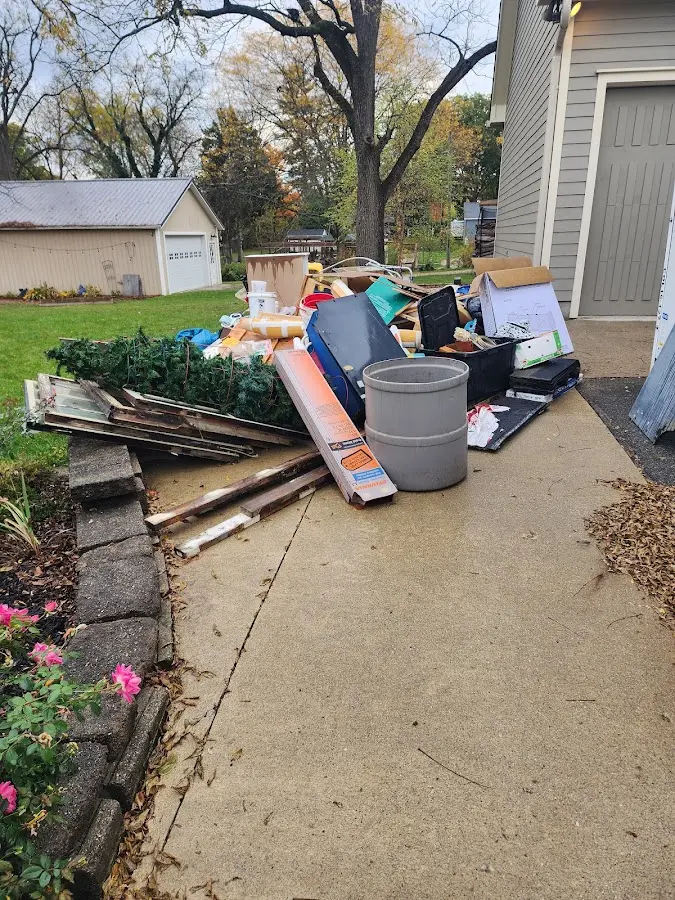 Dumpster being loaded with debris for Estate Cleanout Dumpster Rental in Osawatomie